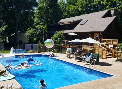 Pool With Wooden Deck During Luxury Vacation