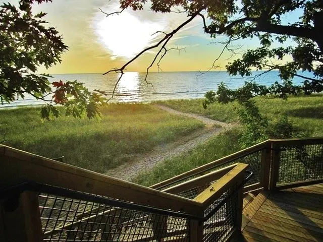 A stairway leading down a beach during sunset