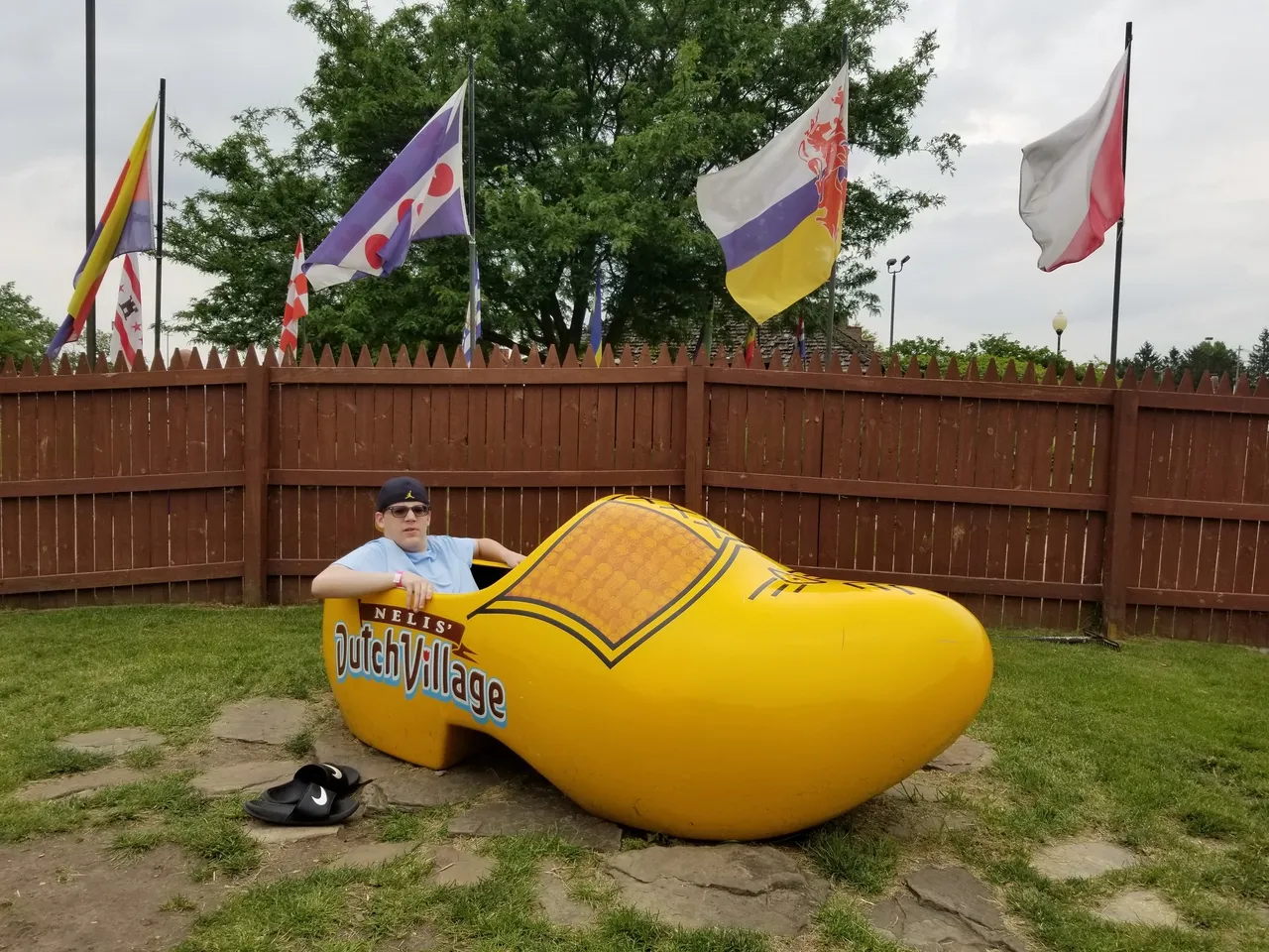 A man inside a giant wooden shoe