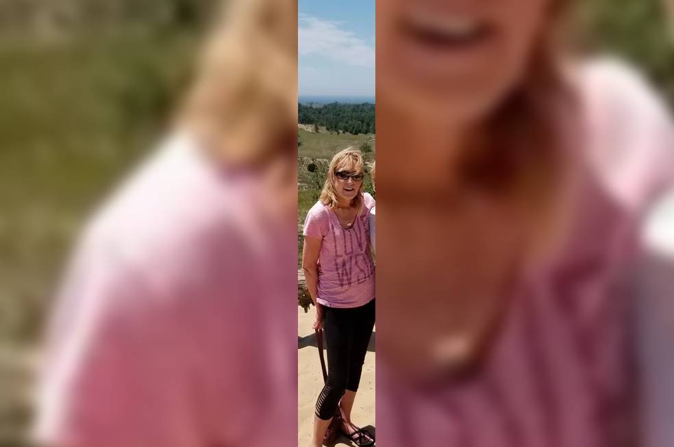 A woman wearing pink tshirt posing for a photo